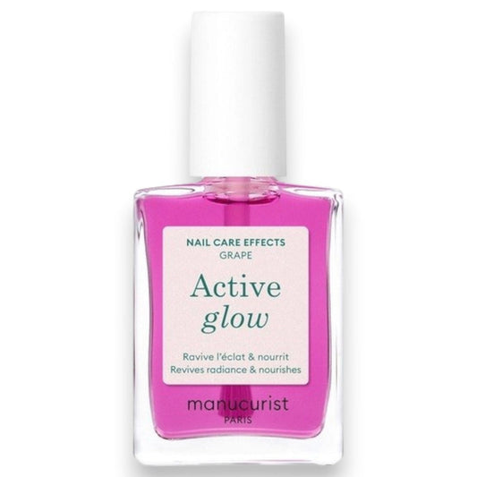 A clear bottle of MANUCURIST - ACTIVE™ GLOW CARE POLISH from MANUCURIST INC features a white cap and vibrant pink liquid. The label displays “Active Glow” and showcases its nail care benefits, grape scent, and nourishing qualities. This bio-sourced polish strengthens nails while providing a sophisticated glass-nails effect for a radiant, healthy-looking finish.