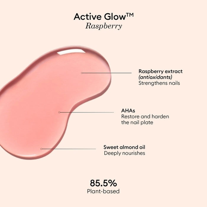 A clear bottle of MANUCURIST - ACTIVE™ GLOW CARE POLISH from MANUCURIST INC features a white cap and vibrant pink liquid. The label displays “Active Glow” and showcases its nail care benefits, grape scent, and nourishing qualities. This bio-sourced polish strengthens nails while providing a sophisticated glass-nails effect for a radiant, healthy-looking finish.