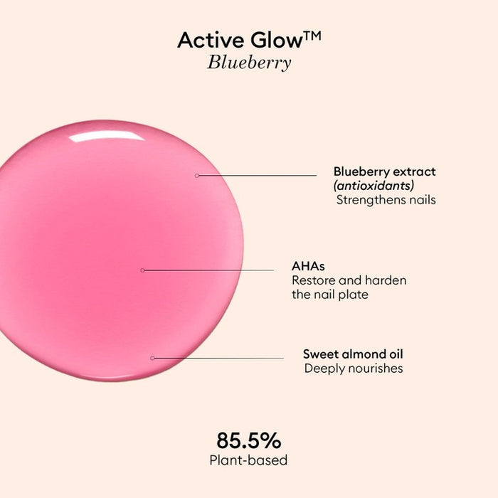 A clear bottle of MANUCURIST - ACTIVE™ GLOW CARE POLISH from MANUCURIST INC features a white cap and vibrant pink liquid. The label displays “Active Glow” and showcases its nail care benefits, grape scent, and nourishing qualities. This bio-sourced polish strengthens nails while providing a sophisticated glass-nails effect for a radiant, healthy-looking finish.