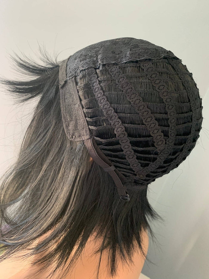 Black lace front wig with a ponytail on a plain background