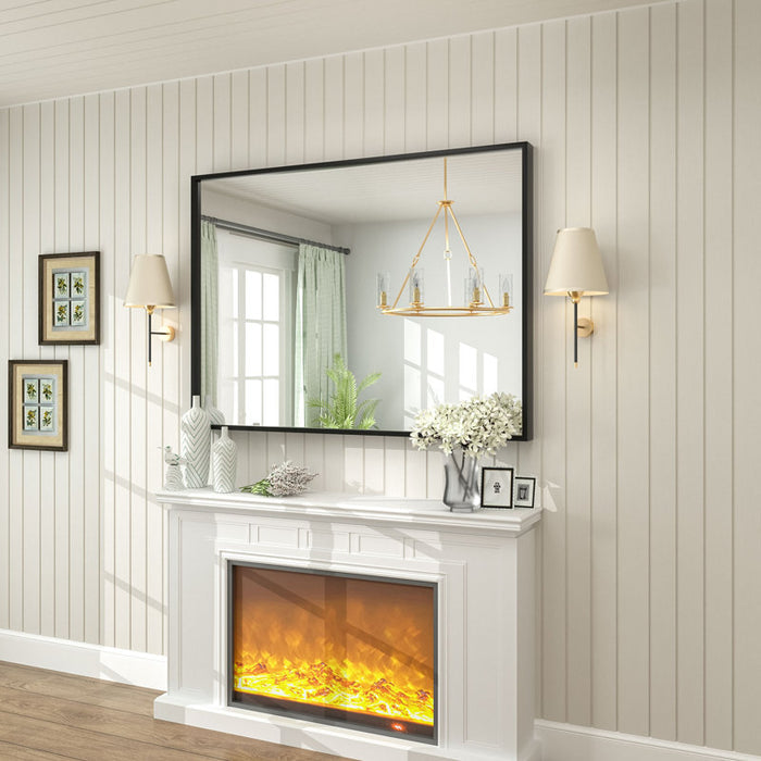 Electric fireplace with a mirror above it in a room with wooden flooring and white walls.
