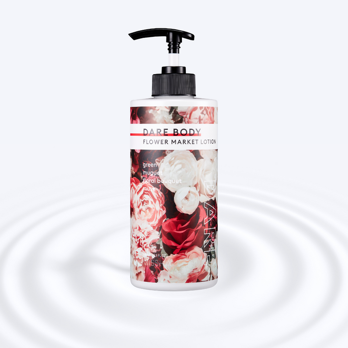 MISSHA Dare Body Flower Market Lotion bottle with a black pump, featuring a floral design of red, white, and pink roses. The label lists fragrance notes including green, muguet, floral bouquet, and musk. The product is placed against a soft white rippled background suggesting hydration and smooth texture.