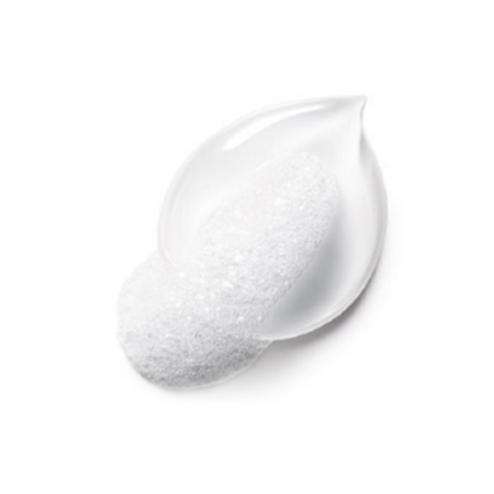Close-up of a white foamy skincare texture with a glossy, gel-like base beneath it, shaped like a teardrop. The image highlights a lightweight, creamy formulation often used for cleansers or moisturizers.