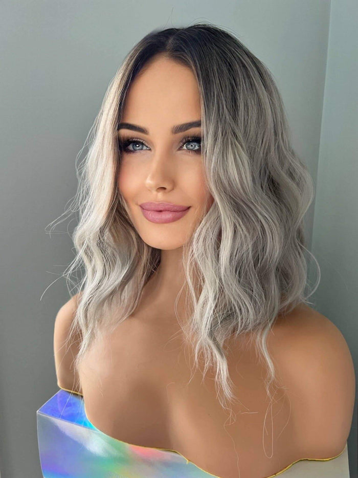Woman with wavy hair against a plain background