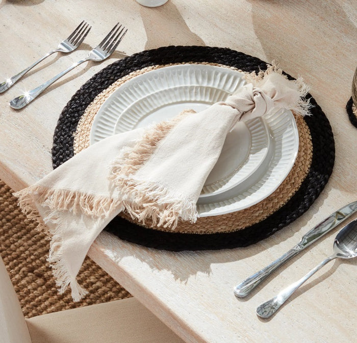The NAPA HOME AND GARDEN Aura Dinner Napkin in Taupe features a soft hue and fringed edges, bringing a cozy touch to your table linens.