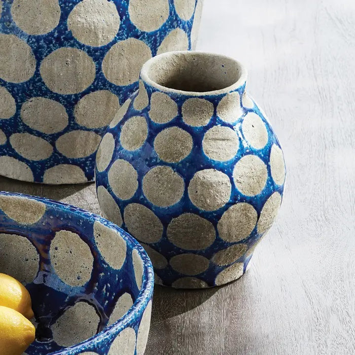 The NAPA HOME AND GARDEN Kiley Vase in Blue, Small, is a round ceramic piece featuring a handcrafted textured surface with bold white polka dots arranged in a stylish pattern.