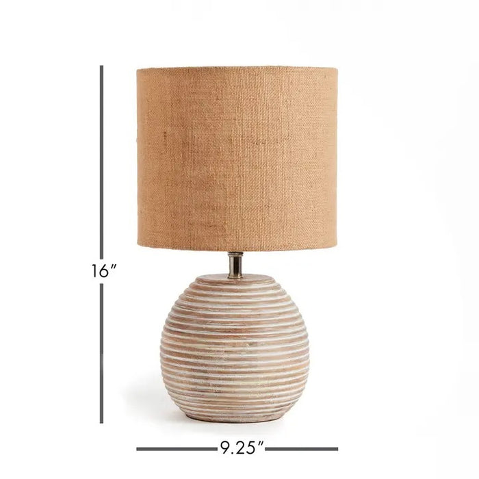 The NAPA HOME AND GARDEN - MADDIE TABLE LAMP features a round, ribbed ceramic base in light beige and a textured brown natural linen shade, adding simple modern style to any room.