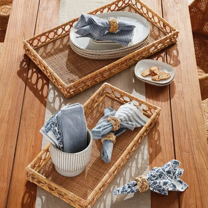 The NAPA HOME AND GARDEN Ninette Rectangular Rattan Tray, Large, features raised sides and a decorative open circle edge in natural beige—ideal for bringing boho coastal charm to your home decor.