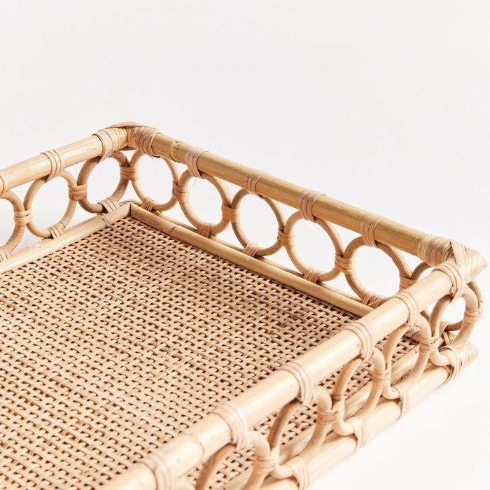 The NAPA HOME AND GARDEN Ninette Rectangular Rattan Tray, Large, features raised sides and a decorative open circle edge in natural beige—ideal for bringing boho coastal charm to your home decor.