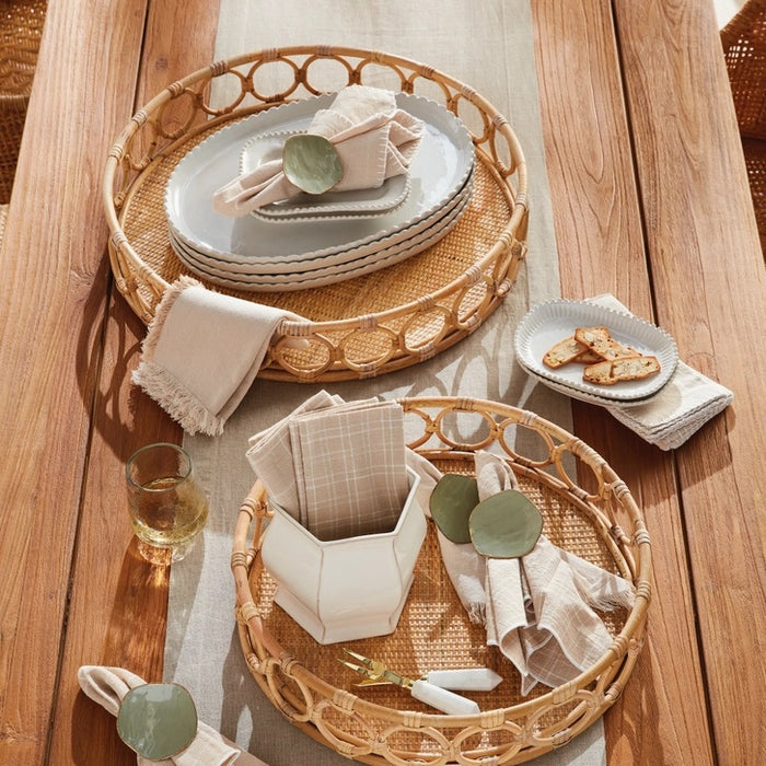 The NAPA HOME AND GARDEN Ninette Round Rattan Tray, Large, features a woven base and open circular sides—an ideal boho accent for lovers of natural rattan decor.