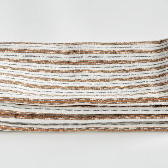Elevate your table linens collection with the NAPA HOME AND GARDEN - SUTTON DINNER NAPKIN. This folded cotton napkin, featuring brown, white, and gray vertical stripes accented by decorative brown stitching along the edges, offers a stylish soft ochre touch—perfect for bringing both elegance and versatility to any dining setting. Displayed against a crisp white background, it’s a standout piece from NAPA HOME AND GARDEN.