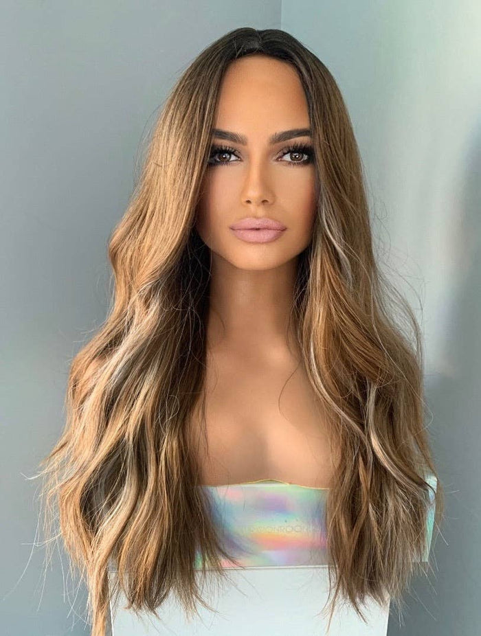 Mannequin head with long, wavy brown hair on a plain background
