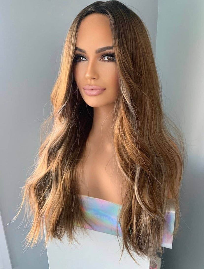 Person with long, wavy hair styled in a way that highlights the color gradient from black to blonde.