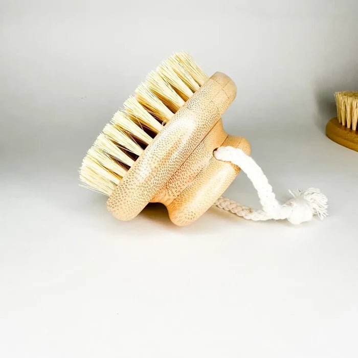 Body brush with bristles and a handle on a light background
