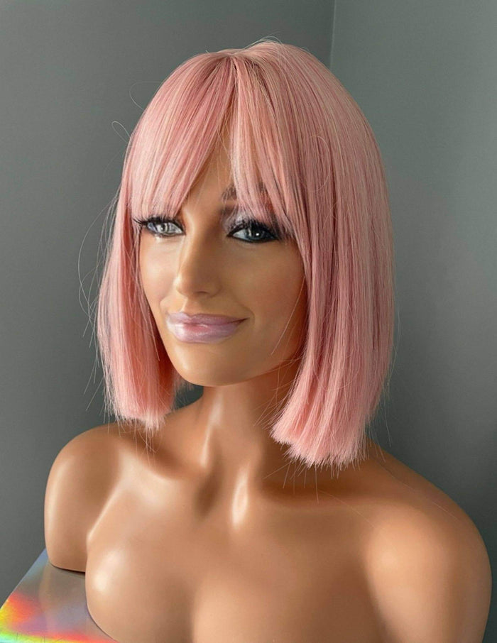 Nia Short Baby Pink Bob Wig showcasing soft pastel pink tones and bangs on a mannequin head