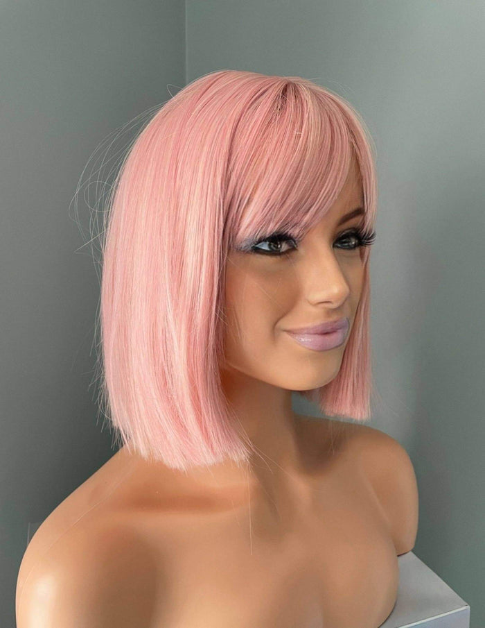 Nia Short Baby Pink Bob Wig showcasing soft pastel pink tones and full bangs on a mannequin head.