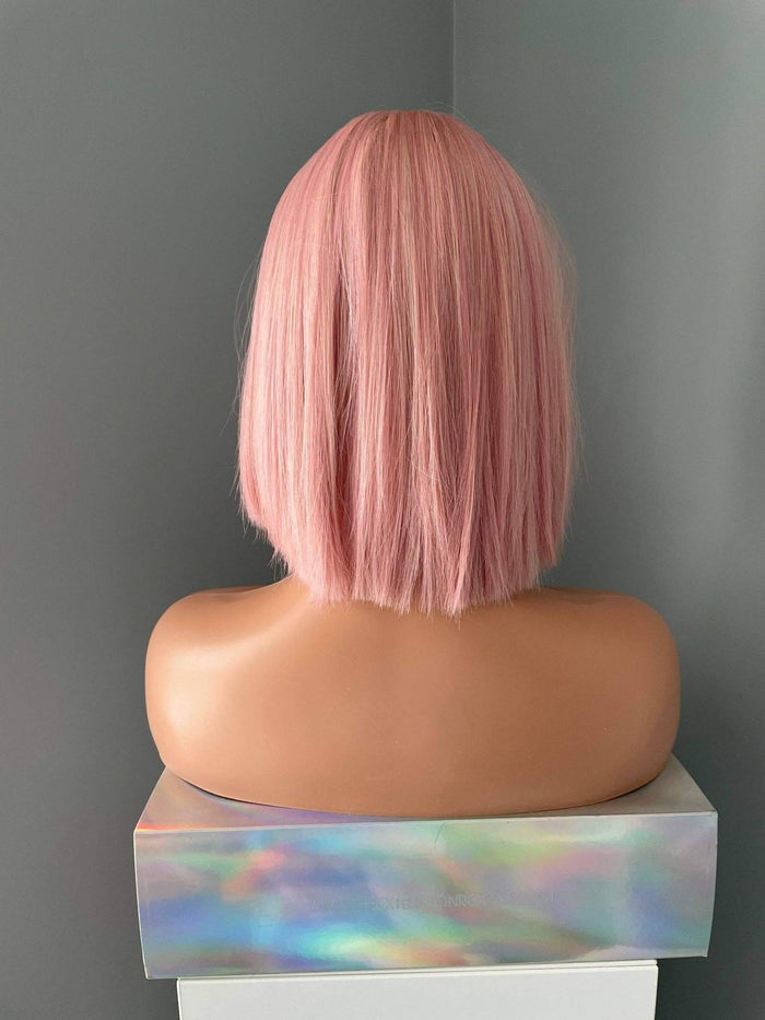 Back view of Nia Short Baby Pink Bob Wig, showcasing its stylish blunt cut and soft pastel pink color.