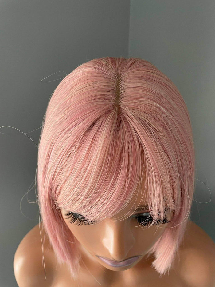 Nia Short Baby Pink Bob Wig showcasing soft pastel pink tones and full bangs on a mannequin.