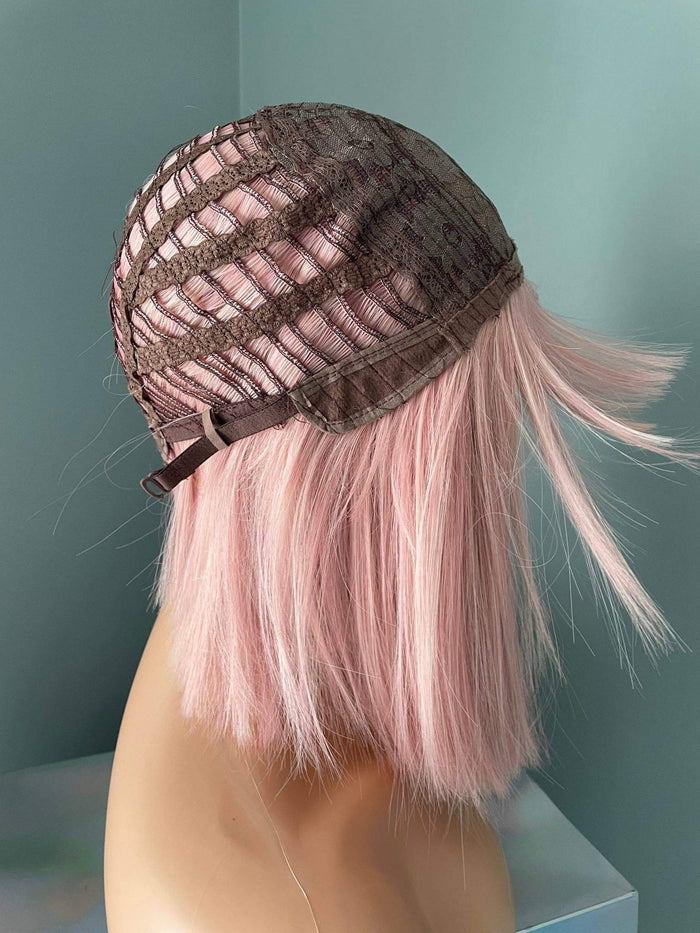 Back view of the Nia Short Baby Pink Bob Wig showcasing the interior cap construction for a secure fit.