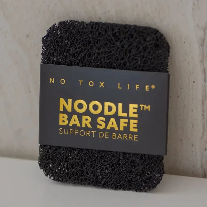 Black sponge with 'No Tox Life' label on a neutral background