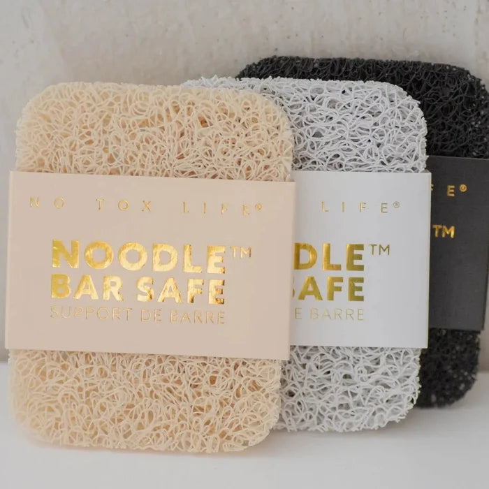Three sponges with labels on a neutral background