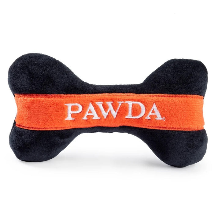 The HAUTE DIGGITY DOG PAWDA BONE DOG TOY is a chic black and orange plush bone with "PAWDA" embroidered in white on the orange stripe—an essential accessory for your stylish pup.