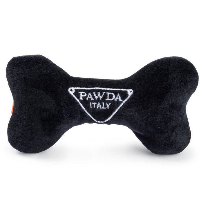 The HAUTE DIGGITY DOG PAWDA BONE DOG TOY is a chic black and orange plush bone with "PAWDA" embroidered in white on the orange stripe—an essential accessory for your stylish pup.