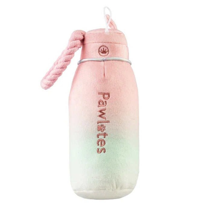 The HAUTE DIGGITY DOG PAWLATES PRINCESS WATER BOTTLE DOG TOY features a soft, pastel pink and green ombre plush design with "Pawlates" embroidered on the bottle and a pink rope handle on the side, making this squeaker dog toy both adorable and entertaining for your pup.