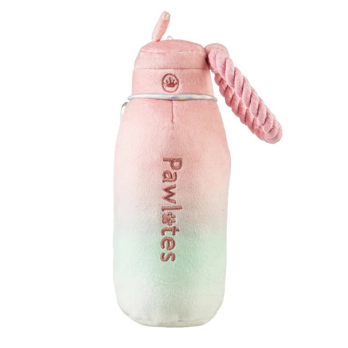 The HAUTE DIGGITY DOG PAWLATES PRINCESS WATER BOTTLE DOG TOY features a soft, pastel pink and green ombre plush design with "Pawlates" embroidered on the bottle and a pink rope handle on the side, making this squeaker dog toy both adorable and entertaining for your pup.