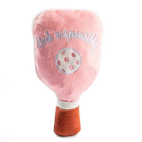 The HAUTE DIGGITY DOG PINK CHECKER PICKLEBALL PADDLE DOG TOY is a plush, paddle-shaped squeaky dog toy featuring a fun pink checkered design, an embroidered pickleball, the phrase "just dink it." in green, and a brown handle—perfect for pups who want to join in on your pickleball passion.