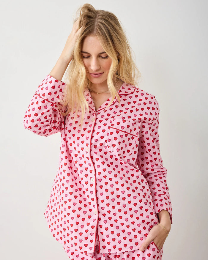 A seamless pattern of red and pink hearts arranged in neat rows on a light pink background, featured on the PRINTFRESH - MINI CANDY HEARTS LONG PAJAMA SET by PRINTFRESH, perfect for cozy Valentine's pajamas.