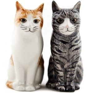 The QUAIL CERAMICS Squash & Patience Cat Salt & Pepper Shakers by QUAIL DESIGNS feature two hand-painted ceramic cat figurines sitting back to back—one in gray with black stripes and the other in orange with white patches. Each cat is looking away from the other, making this charming set a perfect gift for cat lovers.