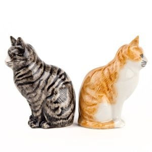 Add a playful touch to your table with the QUAIL DESIGNS QUAIL CERAMICS - SQUASH & PATIENCE CAT SALT & PEPPER SHAKERS. This charming set features two hand-painted ceramic cat figurines: one white with orange spots and one gray with black stripes, both sitting side by side with upright ears and detailed facial features. An ideal cat lover gift for any home!.