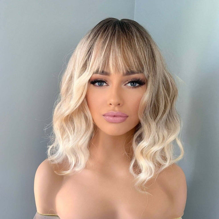Rebecca Short Blonde Body Wave Wig with Bangs styled on a model, showcasing soft waves and full bangs.