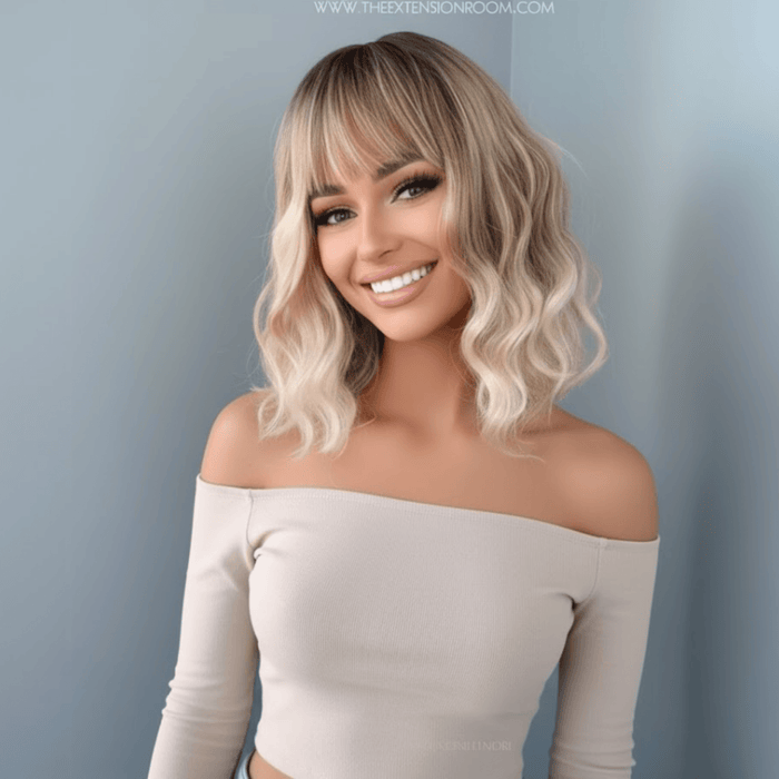 Rebecca Short Blonde Body Wave Wig with Bangs styled on a model, showcasing soft waves and bangs.