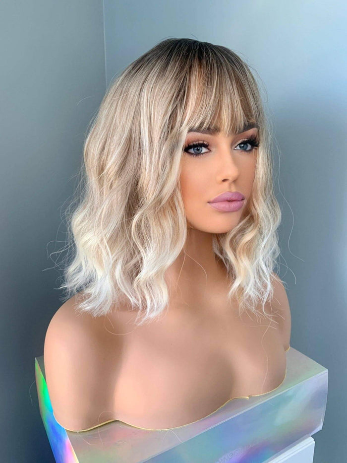 Rebecca Short Blonde Body Wave Wig with Bangs showcasing soft waves and bangs on a mannequin.