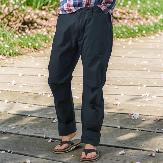 RELWEN - Flyweight Flex Chino in Dark Navy: A lightweight pair of chinos with two back pockets, button closures, and visible stitching, shown laid flat on a white background.