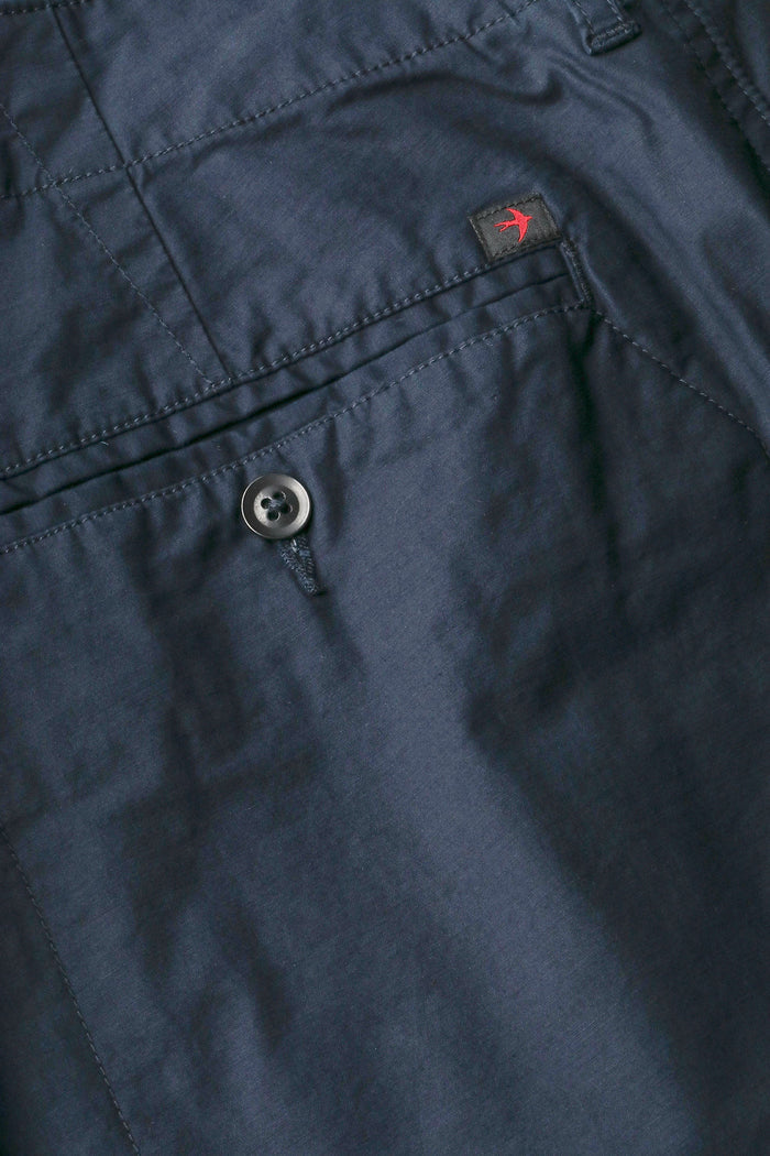 RELWEN - Flyweight Flex Chino in Dark Navy: A lightweight pair of chinos with two back pockets, button closures, and visible stitching, shown laid flat on a white background.