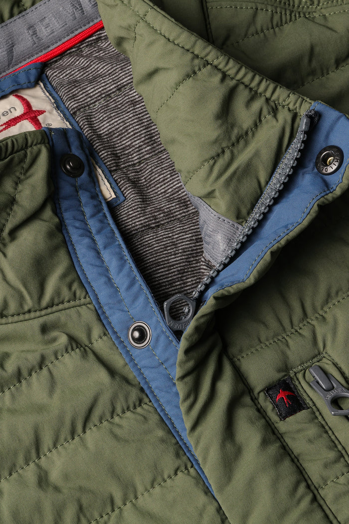 The RELWEN Windzip Vest in Olive is a quilted utility vest with green and blue trim, snap button closures, armholes, and an inner pocket—ideal for layered warmth. Shown open and laid flat.