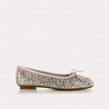 The REQINS HARMONY Sequin Ballerina Flat in Ice features a sparkling design with subtle pink trim and a small bow on the toe, shown from above against a plain light background.