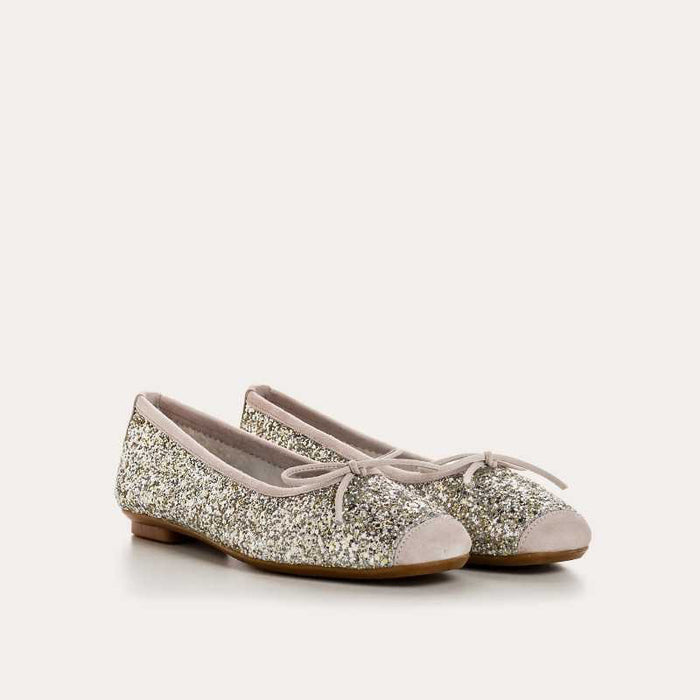 The REQINS HARMONY Sequin Ballerina Flat in Ice features a sparkling design with subtle pink trim and a small bow on the toe, shown from above against a plain light background.