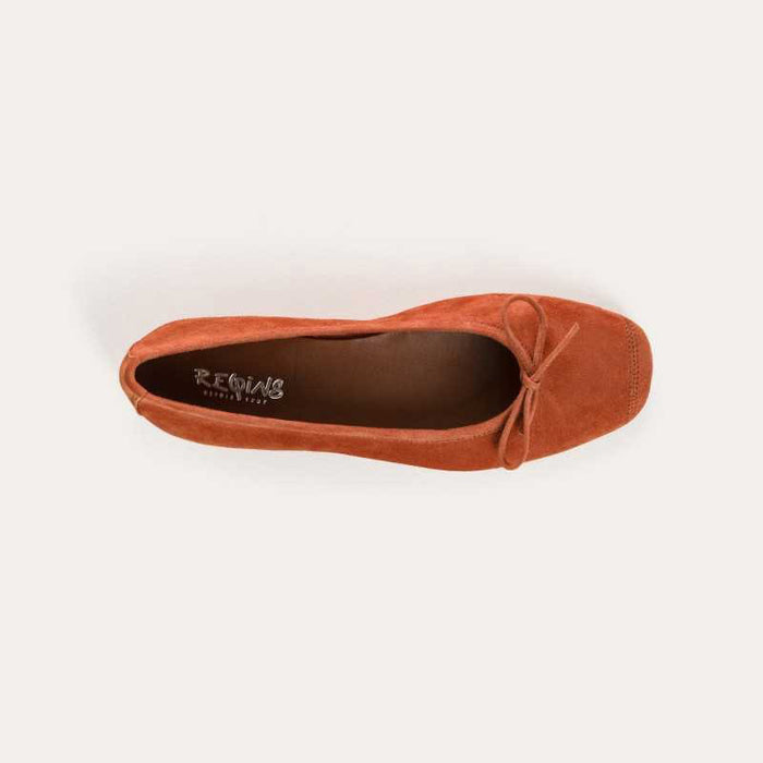 The REQINS - HARMONY Suede Ballerina Flat in Brique is shown in soft suede goatskin with a small bow on the toe, displayed side view against a plain white background.