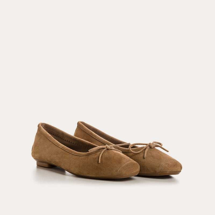 Top view of the REQINS - HARMONY SUEDE BALLERINA FLAT IN NATURAL, featuring a square toe and elegant bow detail—classic women's footwear by REQINS on a simple light background.