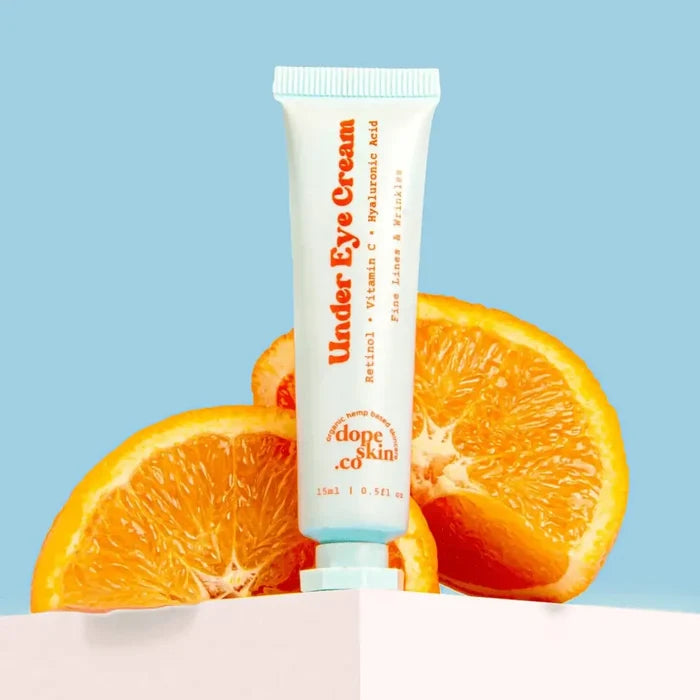 Tube of 'Under Eye Cream' with oranges on a light blue background