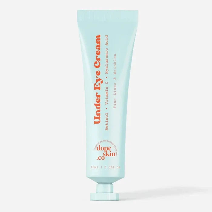 Tube of Under Eye Cream by dope skin co on a light blue background