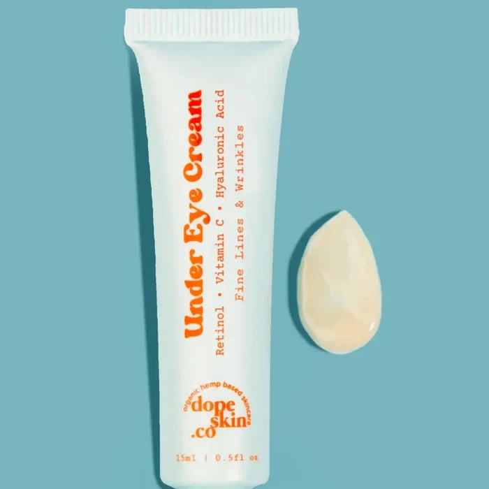 Under Eye Cream tube with a droplet on a light blue background