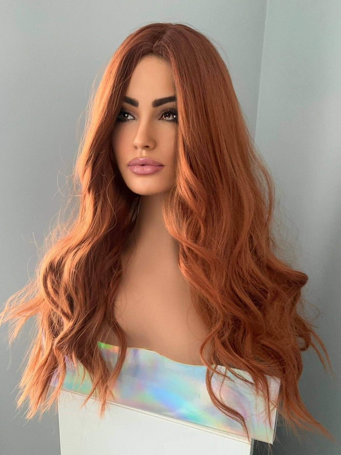 Riri Long Red Auburn Loose Curls Wig displayed on a mannequin showcasing its vibrant auburn and copper-red tones.