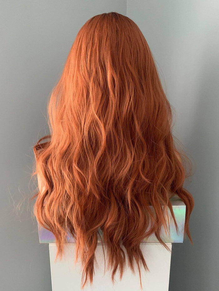 Back view of the Riri Long Red Auburn Loose Curls Wig, showcasing vibrant auburn waves and luxurious volume.