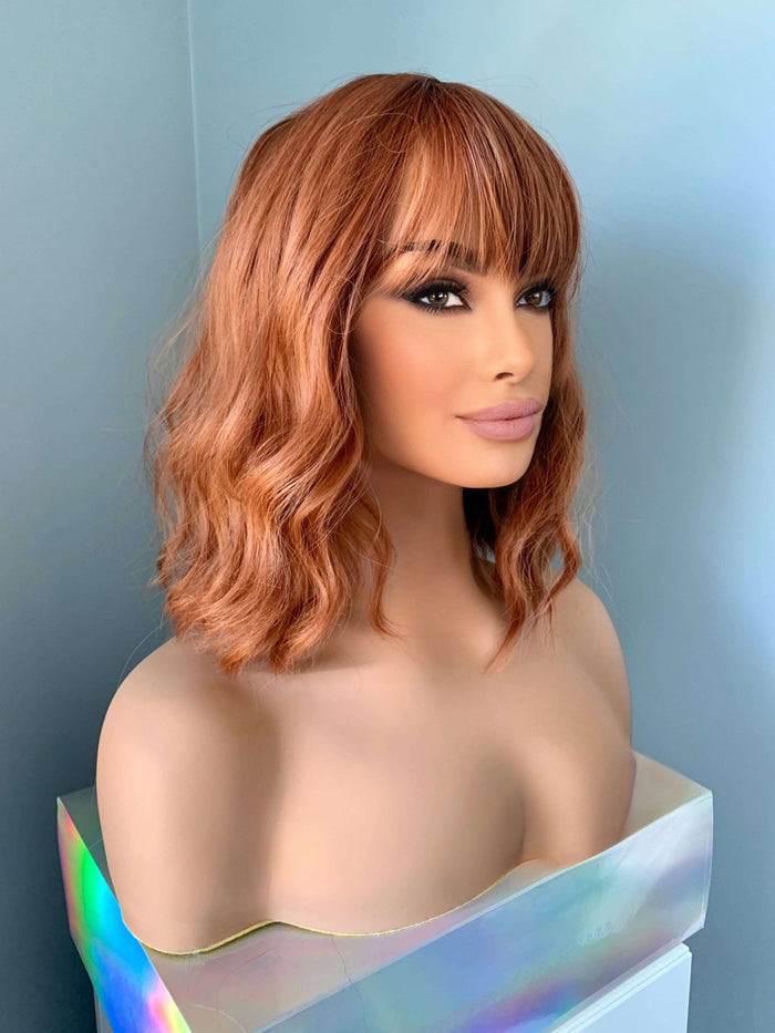 Robin Short Auburn Body Wave Wig with Bangs displayed on a mannequin, showcasing its chic hairstyle.