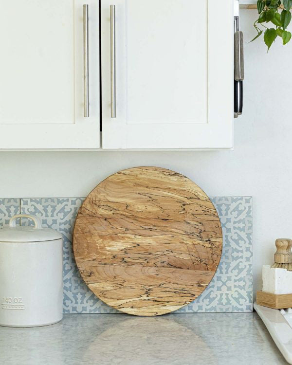 The ROUND SPALTED BOARD 20 by PETERMANS BOARDS & BOWLS INC is a wood-grained oval board crafted from upcycled wood.